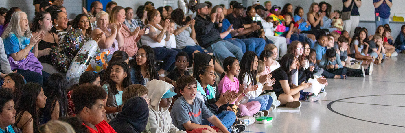 students clapping at assembly 